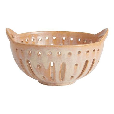 We've reimagined the classic farmers market berry basket as a gorgeous ceramic colander dipped in a brown reactiveglaze finish. Artfully placed drainage cutouts allow water to pour through quickly for easy rinsing while enhancing the chic look of its overall design. With two handles and a small footed base, this artisan berry bowl helps prep fruits and vegetables in the kitchen before presenting them beautifully at the table.