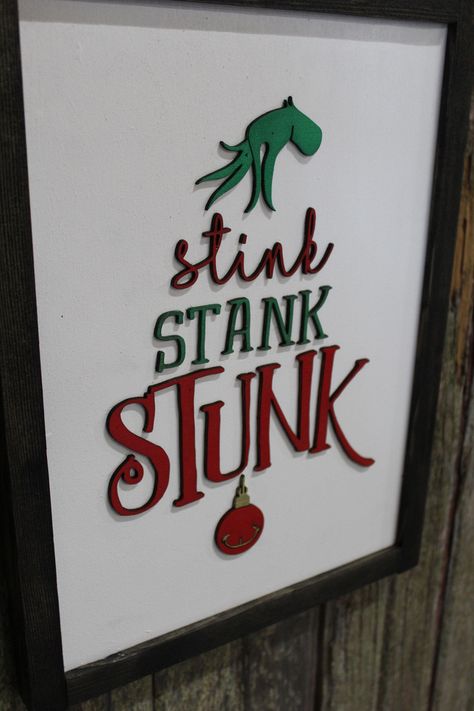 Welcome to Footsteps in the Past! Title: Stink Stank Stunk Sign Raised 3D Wood Grinch Christmas Décor Decoration Wall Art Farmhouse Rustic Primitive Fingers Smile Hand Festive We are offering a handmade wood sign, created right here in our barn.    The background is painted white, and the frame is stained ebony.  The image is raised and stands off of the backerboard.  It measures about 10.5 x 14 inches. Il Grinch, Grinch Sign, Laser Christmas, Cricket Crafts, Grinch Decorations, Christmas Signs Diy, Stink Stank Stunk, Christmas Wooden Signs, Grinch Christmas Decorations