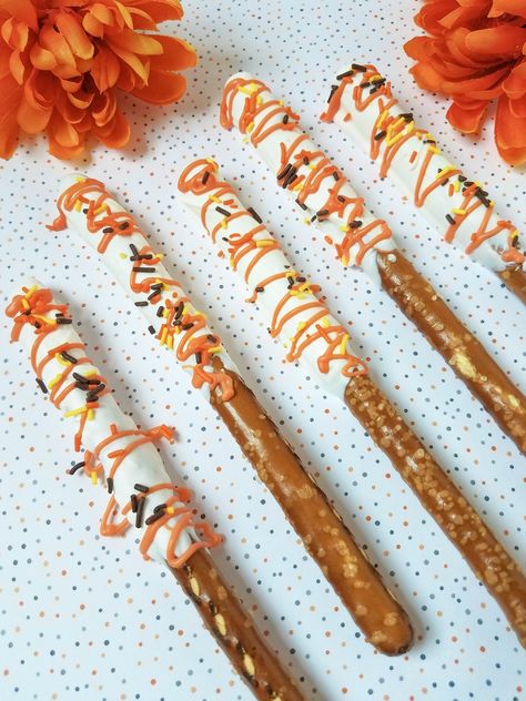 I love easy recipes that I can make with my kids, and these HAPPY FALL Autumn Dipped Pretzel Rods fit that bill nicely. This recipe is simple, only uses a few ingredients, and comes together quickly. Once your decorated pretzels are dried, cooled, and set, they can even be wrapped nicely in cellophane as little individual gifts for teachers, neighbors, and friends. The basic recipe can be adapted to any holiday, season, school colors, or birthday party color scheme, too. Play around with it and Fall Pretzel Rods, Fall Pretzels, Dipped Sweets, Decorated Pretzels, Dipped Pretzel Rods, Chocolate Caramel Pretzels, Sweets Ideas, Chocolate Covered Pretzel Rods, Fall Appetizers