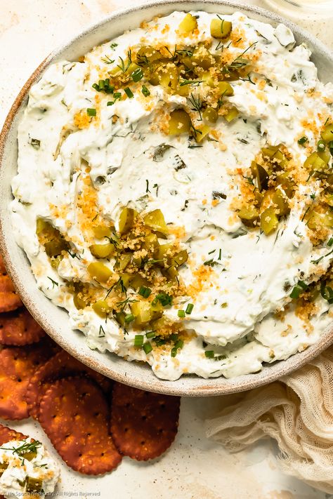 Overhead photo of copycat Ranch Pickle Dip garnished with chopped pickles, dill and crunchy breadcrumbs in a white bowl with pretzel chips next to the bowl. Fried Pickle And Ranch Dip, Pickle Ranch Dip, Dill Pickle Ranch, Pickle Ranch, Dill Pickle Dip Recipe, Pickle Dip Recipe, Pretzel Chips, Dill Pickle Dip, Ranch Dip Recipe