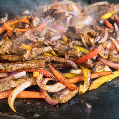 Blackstone Steak Fajitas - Gimme Some Grilling ® Black Stone Steak Fajitas, Blackstone Fajitas, Blackstone Steak, Steak Peppers And Onions, Flat Top Recipes, Steak Peppers, Easy Steak Fajitas, Blackstone Grill Recipes, Black Stone Griddle