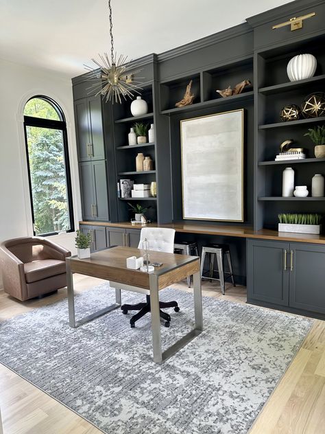 Work from home vibes. 🏡🤍  Transitional design featuring a mix of earthy tones, moody cabinetry, and white oak floors.   #homeoffice #officedesign #officedecor #homedesign #transitionaldesign #whiteoakfloors #earthytones #customcabinetry #builtins #ironore #sherwinwilliams #indyinteriordesigner #interiordesign #akinteriorhome   Follow my shop @akinteriorhome on the @shop.LTK app to shop this post and get my exclusive app-only content!  #liketkit #LTKHome #LTKFindsUnder100 #LTKFindsUnder50 @shop.ltk https://liketk.it/4HwMA Home Office Built Ins With Filing Cabinet, Dark Office Built Ins, Dark Built Ins, Grey And White Office, Transitional Study, Home Office With Built Ins, Office Redo, Home Office Designs, Home Office Built Ins