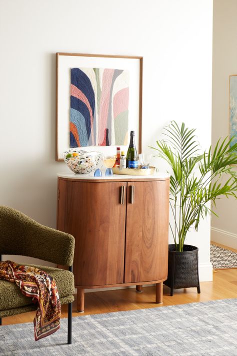 Featuring a curved wood frame in a warm chestnut finish and an oval white marble surface, the Caitlin Marble Top Bar Cabinet packs ample storage into a compact size. It opens to a large compartment with stemware racks, storage for wine bottles, and space for barware. With a genuine marble surface for serving, this versatile bar cabinet makes a lovely impression when entertaining. #WorldMarket #CaitlynBarCabinet #BarCabinet #MarbleCabinet #DiningRoomDecor #HomeBar Bar Cart Cabinet, Japandi Farmhouse, Marble Bar Top, Credenza Desk, Retro Nautical, Contemporary Dining Tables, Fresh Interior, Soho House, Nyc Apartment