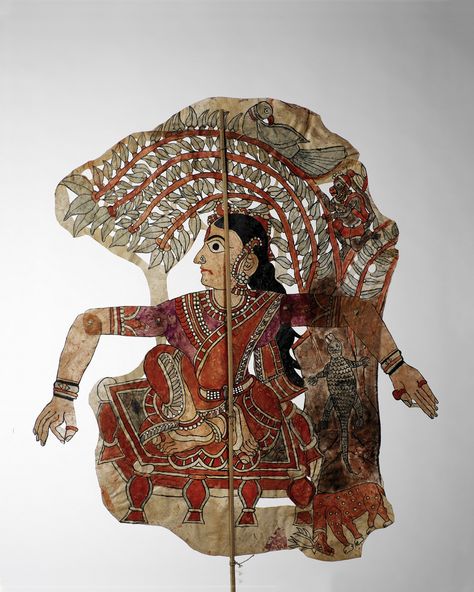 From Andhra Pradesh: Figure of Tholu Bommalata, or shadow theatre. early 20th Century. Made of suede or goat skin, which was cut, sewn, and painted. H: 71 cm. W: 97 cm. "Shadow figure mounted on a wand representing Sita sheltered under a tree with green foliage where a parrot perches. She sits on a four-legged throne. Monkey, deer and crocodile on one side; elephant on the other side. The figures of shadow theatre are called 'Giants of Andhra Pradesh' " Musée du Quai Branly Leather Puppets Of Andhra Pradesh, Tholu Bommalata Designs, Puppet Painting, Shape Characters, Tholu Bommalata, Shadow Puppetry, Volkswagen 181, India Crafts, Ipad Painting