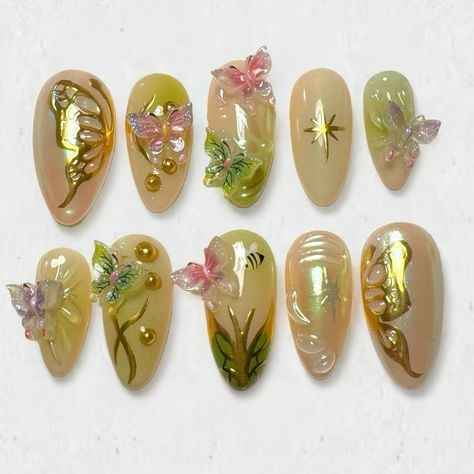 Custom butterfly garden set for @alexiskhana ☆ Prix: 70 CHF ib: @amys.clients & @get.jo.nailsdone ♡ tips are medium almond on the pic #nail #nails #pressonnails #pressons #nailextensions #stickonnails #y2knails #y2k #y2kaesthetic #y2kfashion #nailart #naildesign #naildesigns #3dnails #chromenails #greennails #butterflynails #goldnails Butterfly Garden Nails, Pink And Green Fairy Nails, Secret Garden Nails, Fairy Acrylics, Winx Inspired Nails, Y2k Junk Nails, Forest Fairy Nails, Butterfly Gem Nails, Pink Fairy Nails