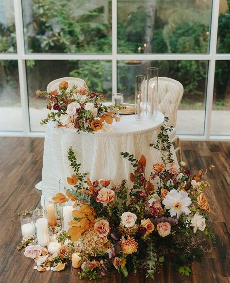 table for bride and groom orange fall florals wedding day decor Muted Fall Floral Arrangements, Outdoor Wedding Reception Flowers, Fall Garden Wedding Decor, Fall Wedding Table Cloths, Fall Wedding Mr And Mrs Table, Fall Boho Chic Wedding, Chic Fall Wedding Decor, Elegant Fall Wedding Flowers, Autumn Sweetheart Table