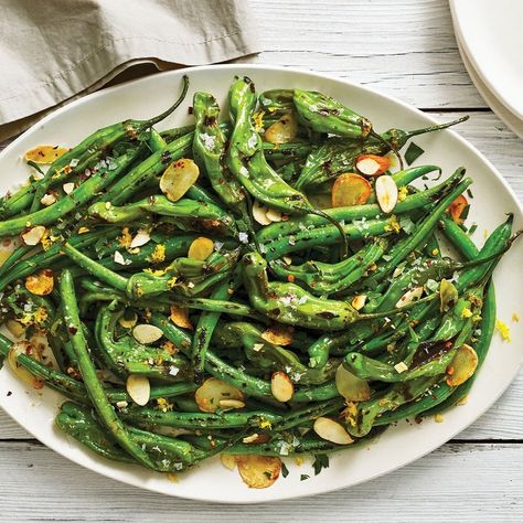 This bowl of blistered shishito peppers and green beans is super snackable. We make them on the stove, so you don't have to heat a grill or broiler. Almond Butter Sauce, Green Beans Side, Green Beans With Almonds, Bean Varieties, Lemon Green Beans, Classic Thanksgiving, Sauteed Green Beans, Cooking Green Beans, Green Bean Salads