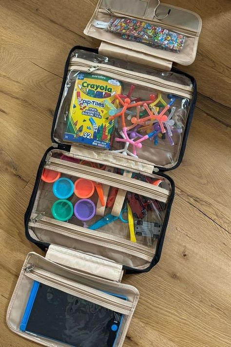 This hanging toiletry bag is a complete lifesaver on the travel days I have with my kids. My kids Busy bag is perfect for long or short trips. I've used it for airplanes, road trips and even at restaurants. I've ranked it in my top 5 essentials for traveling with kids. Tap to shop my favorite travel toys and gadgets for toddlers! Road Trip Organization Travel Hacks, Road Trip Storage, Travel Hacks For Kids, Travel Kit For Kids, Road Trip Essentials For Kids, Diy Travel Kits, Car Trip Organization, Travel Toys For Kids, Essentials For Traveling