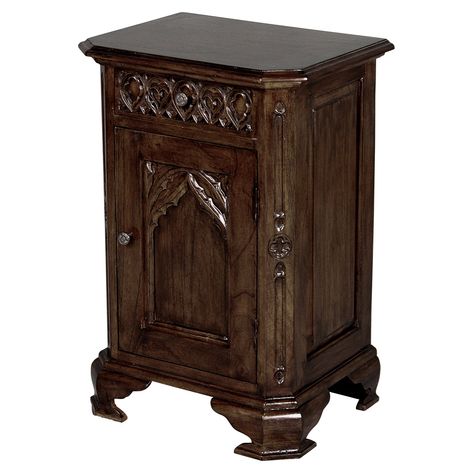 Dimensions: 21W x 15.5D x 31H in.. Crafted out of fine quality mahogany hardwood. Hand-rubbed antique finish. 1 cabinet door. Hand-carved quatrefoil trim and bracket feet. Authentic English Gothic revival antique reproduction. Quatrefoil carvings and a lancet arch give the Design Toscano Queensbury Inn Gothic Revival Bedside Table the ornate look of a carved cathedral door. Like those Gothic portals, the bedside table is painstakingly hand carved by skilled artisans. Solid mahogany wood ensures Gothic Nightstand, Gothic Dresser, Gothic House Decor, Vintage End Tables, Dark Bedside Tables, Gothic Cottage, English Gothic, Gothic Bed, Bedside Table Set