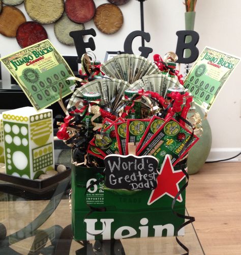 Fathers Day Beer Box  Made this cute gift from a 6 pack of Heineken. With lottery tickets and $20 dollar bills. Cute way to show the father in your life some love. Heineken Gift Idea, 6 Pack Beer Gift Ideas, Fathers Day Gifts Ideas Lottery Tickets, Lottery Ticket Gift Ideas 18th Birthday, Alcohol And Lottery Ticket Basket, Jack Daniels Gift Box Ideas, Father’s Day Tool Box Gift, Lottery Ticket Gift, Valentine Gift For Dad