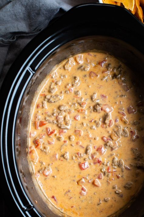 Make Rotel Dip in your slow cooker with Velveeta, ground beef and 2 cans of Rotel Tomatoes. Perfect dip for parties and gameday. - The Magical Slow Cooker Velveeta Slow Cooker Recipes, Velveeta Queso Dip Crock Pot Ground Beef, Crockpot Queso Dip Ground Beef, Velveeta Rotel Dip, Rotel Dip With Ground Beef, Rotel Dip Crockpot, Velveeta Dip, Rotel Dip With Sausage, Rotel Cheese Dip