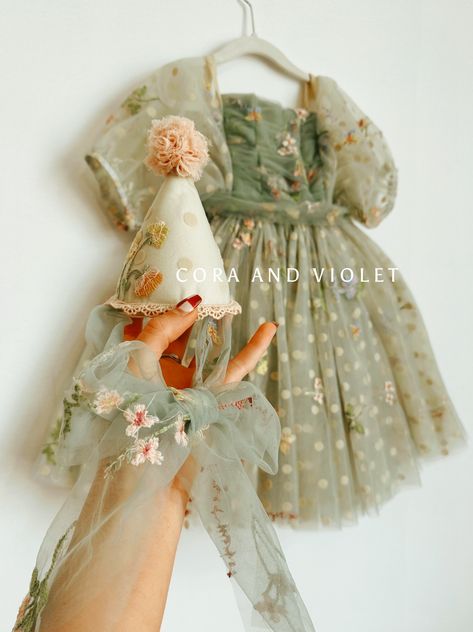 Handmade to order.  Thank you for your patience as little details are hand-placed and made with attention to detail.  For pre-order, It is best to assume the full turnaround when planning to avoid conflicts. Say hello to this spring delight of embroidered flowers atop layered sage green and cream tulle. Flirting under Demeter Cora and Violet Demeter Dress, Botanical Party, Wildflowers And Butterflies, Sage Green And Cream, Flower Birthday Party, Fairy Garden Birthday Party, Loose Tie, Flower Birthday, Garden Birthday