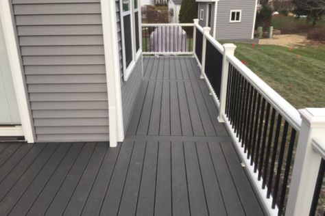 Clam Shell Trex® Deck with White Transcend Railings with Black Aluminum Balusters Barrington | Rock Solid Builders, Inc. Trex Deck Stairs, Deck Stair Railing, Aluminum Balusters, White Deck, Deck Makeover, Black Deck, Deck Colors, Patio Deck Designs, Deck Paint