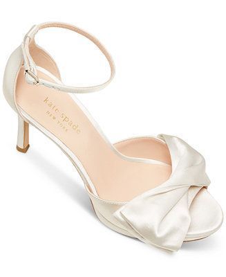 View More A satin bow and slender straps bring femininity to every step in the pretty Bridal Satin dress sandals from Kate Spade New York. 4\" stiletto heel Round-toe ankle strap dress sandals with adjustable buckle closure Satin bow detail at strap Satin Fabric upper; leather lining; leather sole Imported Web ID: 11558598 Bridal Satin Dress, White Bridal Shoes, Bridal Shoes Low Heel, Satin Evening Dress, Jewel Badgley Mischka, Dress Heels, Satin Evening Dresses, Bridal Heels, Heels Online