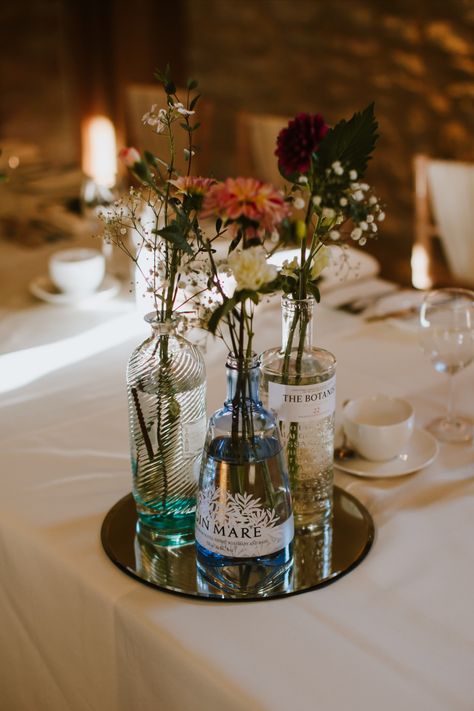 Flowers on table in recycled gin bottle Bottle Centrepiece, Wedding Photo Table, Wedding Table Decoration, Bottle Centerpieces, Gin Bottle, Wedding Bottles, Gin Bottles, Flower Vase, Table Decoration