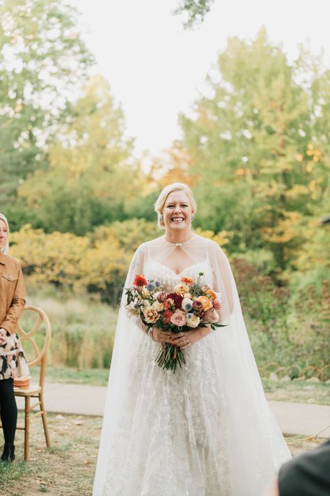 Fall bridal bouquet with local wildflowers. Timeless fall wedding colors for outdoor wedding in September with touches of gold. Fall floral colors with touches of pink, golden yellow, blue, and burgundy. Fall wildflowers for outdoor wedding in Tennessee. Local fall flowers of zinnias, dahlias, and roses for fall wedding. Design by Rosemary & Finch Floral Design in Nashville, TN Timeless Fall Wedding, Fall Wedding Florals, Fall Wildflowers, Wedding In September, Fall Bridal Bouquet, Fall Wedding Color Palette, Bridal Bouquet Fall, Unique Wedding Flowers, Floral Chandelier