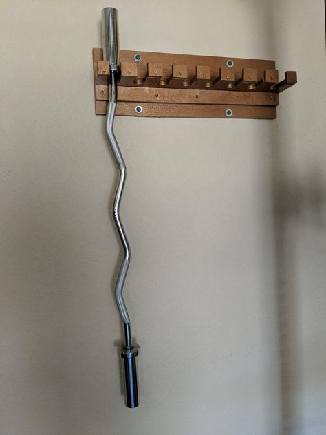 DIY 8 barbell holder. Made with some scrap plywood and painted with metallic oil paint. Nordic Hamstring Curl Diy, Diy Weights, Diy Fitness Equipment, Barbell Storage, Gym Rack, Home Made Gym, Gym Organizer, Home Gym Storage, Home Gym Basement