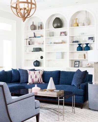 Couch In Front Of Built Ins, Couch In Front Of Bookshelves, Bookshelves In Living Room Modern, Arched Shelves, Arched Bookshelves, Navy Blue And Grey Living Room, Builtin Bookshelves, Family Friendly Living Room, Navy Sofa