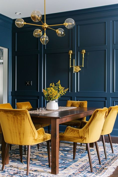 What colors go with navy blue? Mustard yellow and navy blue combine to inject warmth and cheer into your home. This vibrant pairing can brighten up a dining area or add a playful splash of color to a study, balancing the boldness of navy with the lively spirit of mustard. Mustard Dining Room, Navy Blue Dining Room, Navy Dining Room, Copper Dining Room, Moody Rooms, Dining Room Navy, Yellow Dining Room, Navy Blue Decor, Dark Blue Living Room