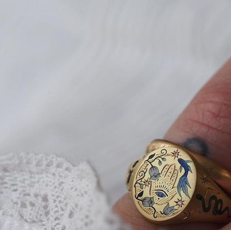 Cece Jewellery on Instagram: "A spiritual Judica-inspired ring... The signet ring features a central engraved Chamsa hand🪬complete with a miniature Evil Eye, oversized crescent moon, white enamel Lily of the Valley twisting their way skywards, and a beautiful swimming fish 🪬📿🐍🕯️#cecejewellery" Cece Jewellery, Spiritual Ring, Swimming Fish, Painted Jewelry, Chunky Rings, Lily Of The Valley, White Enamel, Signet Ring, Crescent Moon