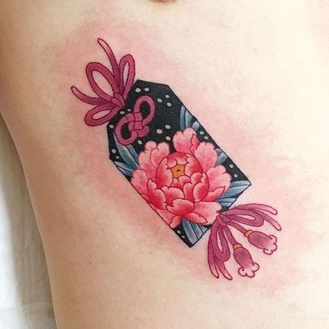 Peony good luck charm tattoo | www.otziapp.com Japanese Omamori Tattoo, Omamori Illustration, Japanese Tattoos For Women, Omamori Tattoo, Omamori Charm, Japanese Tattoo Women, Minimalist Tattoo Meaning, Charm Tattoo, Typography Tattoo