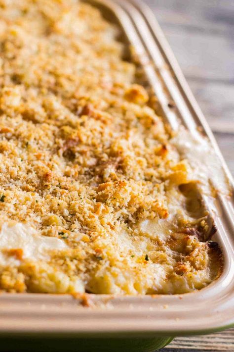 This recipe for Baked Cauliflower Mac and Cheese is like a mashup between cauliflower au gratin and the best mac n cheese. It's a gooey and cheesy macaroni and cheese with a buttery, crunchy top, but also has an entire head of cauliflower inside! This vegetarian cauliflower bake is a major crowd pleaser that can feed up to 12 people so it's great for entertaining! | ColeyCooks.com Baked Cauliflower Mac And Cheese, The Best Mac N Cheese, Best Mac N Cheese, Cauliflower Mac N Cheese, Cauliflower Au Gratin, Cauliflower Bake, Cheesy Macaroni, Cooking Spaghetti, How To Cook Zucchini