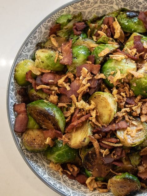 Pan seared brussels sprouts with crumbled bacon and crispy fried onions. A delicious side dish with browned caramelized brussels sprouts that taste similar to being roasted. How To Cook Sprouts, Brussels Sprouts Recipe With Bacon, Crisp Recipes, Crispy Fried Onions, Fried Brussel Sprouts, Bacon Brussel Sprouts, French Fried Onions, Sprouts With Bacon, Sprout Recipes