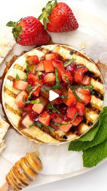 Maegan Brown ~ The BakerMama on Instagram: "Grilled Brie with Strawberries 🍓🍓 If you’ve got ten minutes, you’ve got some major yum for a summer appetizer! 

COMMENT “recipe” and I’ll DM you the link or see RECIPE BELOW ⬇️ #TheBakerMama

GRILLED BRIE WITH STRAWBERRIES

Ingredients:
1 (8 ounce) wheel soft-ripened brie cheese, cold
1 cup strawberries, diced
2 teaspoons balsamic vinegar
2 teaspoons olive oil, plus more for brushing
2 teaspoons honey, plus more for drizzling
1 tablespoon chopped fresh mint leaves, for garnishing
sea salt, for garnishing

Heat the grill to medium and brush the grates with oil. In a medium mixing bowl, whisk together the balsamic vinegar, olive oil and honey. Add diced strawberries and gently stir to combine. Set aside. Remove the wheel of brie cheese from the Roasted Strawberries And Brie, Grilled Cheese Recipes Brie, Grilled Brie With Strawberries, Grilled Brie With Peaches, Brie And Fig Jam Grilled Cheese, Brie Appetizer, Christmas Appetizers Easy, Vegetable Tray, Gluten Free Appetizers