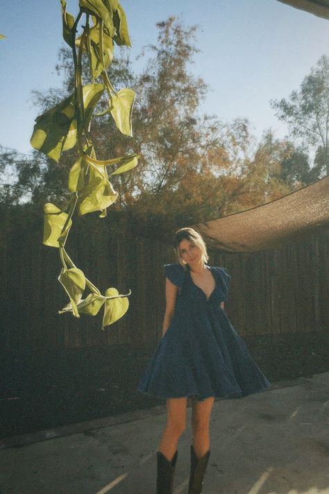 Free People Dress With Cowboy Boots, Black Boots Country Outfit, Free People Cowboy Boots, Floral Dress And Cowboy Boots, Jean Dress With Cowboy Boots, Denim Dress Cowboy Boots, Sundress With Boots, Sundress Cowboy Boots, Dorm Photoshoot