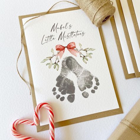 Send your loved ones some Little Mistletoes this Christmas with our Footprint Card Kit. Not only do they make a beautiful keepsake, but they make a fun activity for the family over the festive season.  Each kit contains:  - A5 Personalised Little Mistletoes Cards, printed on high quality white hammered card, in a quantity of your choice. Multiple names can be added e.g 'Name & Name's Little Mistletoes'.  - 1 x Test sheet with instructions, explaining fully how to capture your little one's footprints  - 1 x Baby safe ink pad which is safe to use from birth (if selecting the 'with ink pad' option) - C5 Kraft envelopes for each card  Keeping your baby's skin safe is our number one priority, which is why we have ensured our ink pads are 100% baby-friendly and conform fully to the strict standa Mistletoes Footprint, Mistletoes Footprint Craft, Mistletoe Footprint, Baby Footprints Christmas, Handprint Christmas Cards, Baby Christmas Crafts, Baby Christmas Card, Baby Art Crafts, Baby Christmas Ornaments