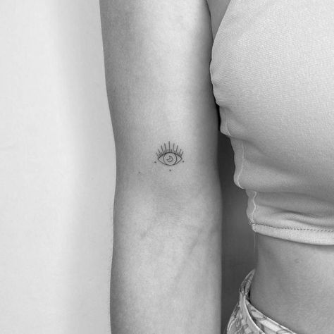 Minimalist evil eye and crescent moon tattoo on the Small Evil Eye Tattoos For Women, Moon Evil Eye Tattoo, Moon Tattoo Bicep, Devil Eye Tattoo, Evil Eye Tattoo For Women, Tattoo Third Eye, Anatomy Eyes, Tiny Tattoo Placement, Tattoo Bicep