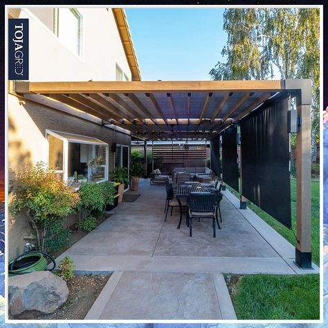 Discover the most stunning pergola attached to house ideas for outdoor living. Transform your backyard with these beautiful and functional designs. Create a cozy outdoor space with a pergola that seamlessly blends with your home. Perfect for entertaining or relaxing in style. Pergola Connected To House, Slanted Pergola Attached To House, Pergola Against House, Metal Pergola Patio Ideas, Patio Awning Attached To House, Contemporary Pergola Designs, Modern Patio Cover, Attached Pergola Ideas, Backyard Shade Structure