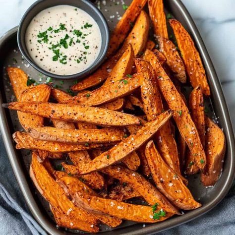 Air Fryer Sweet Potato Fries: A tray of perfectly cooked sweet potato fries, lightly seasoned and served with a side of creamy dipping sauce, sprinkled with herbs. Friendsgiving Dishes, Air Fryer Thanksgiving, Parmesan Zucchini Chips, Air Fryer Sweet Potato Fries, Creamy Dipping Sauce, Air Flyer, Butternut Squash Cubes, Herb Roasted Potatoes, Bacon Wrapped Asparagus