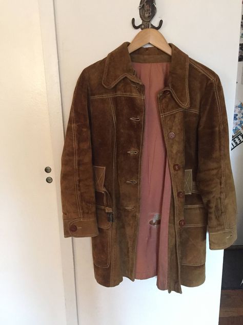 "Here is a groovy, sturdy suede jacket.   It is a heavy one.  Fits with a sweater underneath.  Good for cool weather. Approx. a size 8 Has wood buttons and a belt with brass toggle.   Has big patch front pockets. I love the top stitching on this coat!  One of the buttons is missing and one has fallen off and needs to be sewn on.  The cuff is missing a button and so is the placket button beneath the collar.  That one doesn't detract or look needed, so I would attach the loose button to the cuff. Big Coat, 1970s Winter Outerwear With Buttons, Retro Vintage Brown Outerwear With Button Closure, Vintage Suede Coat, 1970s Long Sleeve Vintage Outerwear, 1970s Fitted Outerwear With Button Closure, New Frock, Brown Leather Coat, Fur Collar Jacket