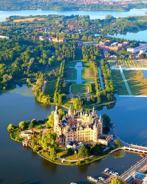 Schwerin Castle ; Schweriner Schloss is a castle located in the city of Schwerin, the capital of the Bundesland of Mecklenburg-Vorpommern, Germany. For centuries it was the home of the dukes and grand dukes of Mecklenburg and later Mecklenburg-Schwerin. It currently serves as the seat of the state parliament.. Schwerin Castle, Europa Park, Germany Castles, Voyage Europe, Beautiful Castles, A Castle, Places Around The World, Aerial View, Dream Vacations