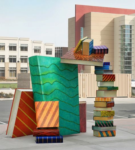 Joseph Bellacera, Catch a Book 2010, 9' x 9' x 7' polychrome steel sculpture, Arthur F. Turner Library, West Sacramento, CA The precariously placed books have literary quotes from authors representing the cultural diversity of the city while the book jackets illustrate local geography and agriculture. aerial landscape painting, aerial abstract, abstract landscape painting, landscape quilt, agricultural landscape painting, rice fields, rice field paintings Book Sculptures, Bookish Art, West Sacramento, Library Art, Book Sculpture, Cool Books, Sacramento California, Book Storage, Book Fair