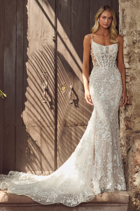 In this wedding dress with an overskirt,there’s no doubt in our minds that you’ll evoke the same majesty of Hera and feel just as beautiful as the goddess herself.Featuring a sheath silhouette adorned with sparkling sequins and intricate lace,this dress transforms with a detachable overskirt,making the arrival at the reception even more breathtaking.Her spaghetti straps create an airy feel, while her low back exudes allure, allowing brides to glide down the aisle while  blending sophistication. Strappy Sheath Wedding Dress, Lace Sparkly Wedding Dress, Mermaid Wedding Dress Corset Top, Wedding Dresses With Overskirt, Tight Wedding Dress Open Backs, Wedding Dresses With Sparkle, Tight Fitting Wedding Dresses, Lace Sparkle Wedding Dress, Wedding Dresses Form Fitting