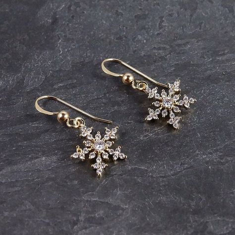 "Our gold snowflake earring is a holiday accessory that is both elegant and sophisticated.  These sparkly, crystal earrings can be worn every holiday season as well as all through winter, and make a great gift for a teacher or coworker. Pair with black pants and a cream sweater for a classic look on Christmas Eve. ▪️▪️▪️▪️▪️▪️▪️▪️ DETAILS * Size: earring length is 1\", snowflake is 0.5\" * Materials: cubic zirconia * Metals: gold filled ear wires, gold plated snowflakes ▪️▪️▪️▪️▪️▪️▪️▪️ DELIVERY Gold Christmas Earrings, Winter Accessories Jewelry, Snowflake Jewellery, Christmas Earings, Winter Wedding Jewelry, Korean Jewellery, Winter Court, Musical Costumes, Snowflake Dress