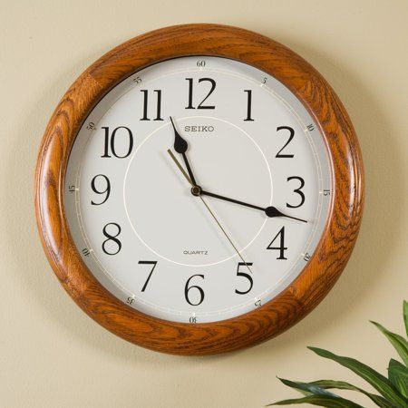 Our #1 Wall Clock! This dark brown solid oak clock with Arabic Numbers and quiet sweep is 13 inches round and brings warmth and sophistication to the home as well as office space. Classically designed, it features a brown case with a wooden grain finish, glass cover, and a quiet sweep second hand. Size: 13 inch.