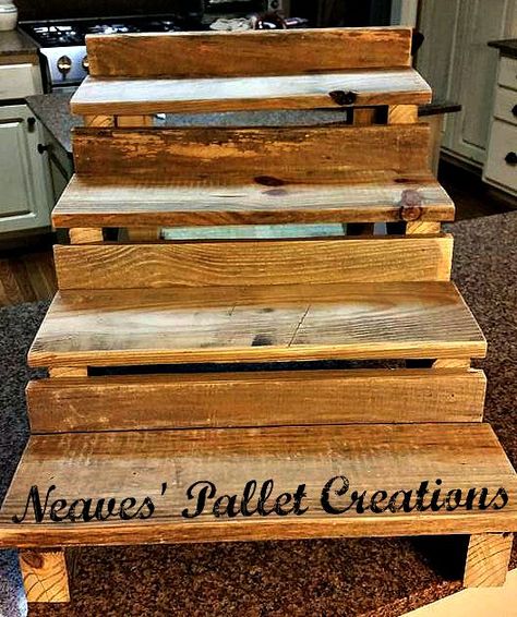 RECYCLED WOOD PALLETS: This is a Cupcake Stand. It has 4 tiers that are 5.5" deep and an overall width of 18". It stands 16" high and is 23" deep.  This table/counter top shelving system could be used for many display ideas. You could put pictures, wine glasses, any tasty treats you desire, or even put Christmas Cards that you have received on display. We are selling this item for $25 "naked" and $35 if we paint/stain it for you. Message us if you would like to place an order. Item #642 Pallet Cupcake Stand, Tumbler Display, Pallet Picture Display, Table Display Ideas, Craft Table Display, Pallet Pictures, Cafe Display, High Dining Table, Table Counter