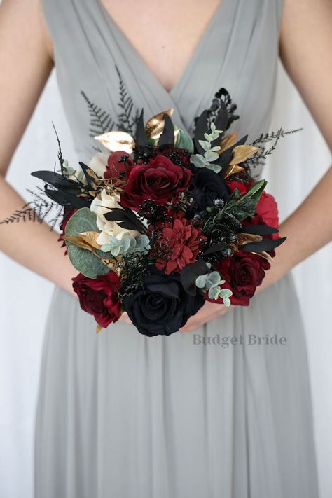 This magnificent rounded brides’ bouquet is crafted using black, burgundy, wine and champagne roses and peonies of the highest quality. This dark and moody bouquet is sure to leave a lasting impression. The delicate gold accents in this collection, create a bright and dazzling arrangement that is sure to turn heads. With a mixture of mixed black foliage and greenery this bouquet is sure to make a statement. All of our bouquets are a wonderful option for destination weddings, as they can be bough Moody Bouquet, Black Rose Bouquet, Simple Boutonniere, Fake Wedding Flowers, Champagne Roses, Flower References, Flower Boquet, Fresh Wedding Flowers, Roses And Peonies