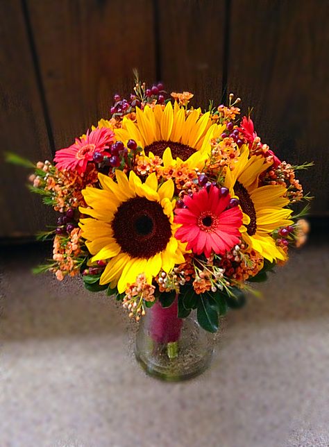 Fall bridal bouquet with sunflowers, gerber daisies, wax flower and hypericum berries Flower Arrangements With Gerber Daisies, Sunflower And Gerber Daisy Bouquet, Gerber Daisy Bouquet Floral Arrangements, Gerber Daisy Arrangements, Gerber Daisy Centerpiece, Sunflower And Daisy Bouquet, Bouquets With Sunflowers, Gerber Daisy Bouquet, Gerber Daisy Wedding