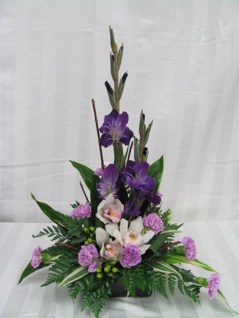 Glads, orchids & moon carnations. www.carolynsfloraldesigns.com Gladiolus Arrangements, Fresh Flower Arrangement, Contemporary Flower Arrangements, Tropical Floral Arrangements, Tropical Flower Arrangements, Easter Flower Arrangements, Purple And White Flowers, Large Flower Arrangements, Flower Arrangement Designs