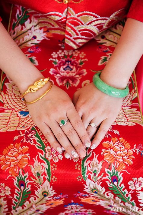 In Chinese culture, gold and jade accessories are a big part of a bride's outfit! | WedLuxe – A Storybook Wedding | Photography by: Hong Photography and Cinema Inc. Follow @WedLuxe for more wedding inspiration!  #wedluxe #wedluxemagazine #storybook #storybookwedding #whitewedding #weddinginspo #chinesewedding #jewellery #chinesewedingjewelery #jade #jadebracelet #gold #goldbraclet Jade Bangle Outfit, Chinese Wedding Jewelry, Chinese Gold Jewellery, Jade Jewelry Chinese, Bangle Outfit, Chinese Wedding Photos, Jade Accessories, Braclets Gold, Jewellery Shoot