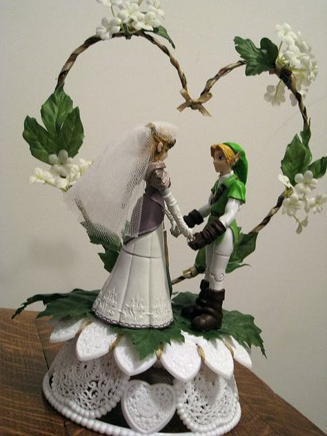 Zelda and Link wedding topper. I've decided (about five minutes ago) I'm going to have a Zelda themed wedding. (Mainly so I can wear those zelda shoes). Now I gots to find me a nerdy man! Hyrule Compendium, Geek Wedding Cake, Nerdy Wedding Cakes, Zelda Cake, Video Game Wedding, Zelda Wedding, Gamer Wedding, Hyrule Castle, Nerd Wedding