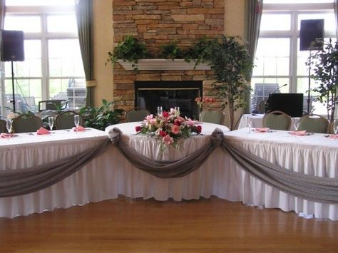 1 round table and 2 banquet for the bridal party table. Love the table skirts and gray drape on front. No angle though, want them lined up straight. Head Table With Sweetheart Table, Wedding Party Tables Ideas, Decorating Ideas For Wedding Tables, Parents Table At Wedding Reception, Bridal Party Seating Head Tables, Sweetheart Table Vs Head Table, Sweetheart Table With Wedding Party, Setting Up Tables For Wedding Reception, Wedding Head Table Ideas Receptions