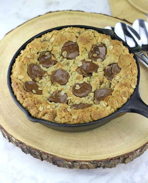 Peanut Butter Cup Oatmeal Chocolate Chip Skillet Cookie is baked to a golden brown and it's awesome served melty-warm right out of your cast-iron skillet. Wait till you taste this yummy, gooey peanut butter oatmeal cookie with chocolate chips and peanut butter cups! To take it top level, bring on the creamy vanilla ice cream and some chocolate syrup! Chocolate Chip Skillet Cookie, Peanut Butter Sandwich Cookies, Peanut Butter Oatmeal Bars, Skillet Chocolate Chip Cookie, Iron Recipes, Skillet Cookie, Peanut Butter Oatmeal Cookies, Peanut Butter Sandwich, Peanut Butter Chocolate Chip Cookies