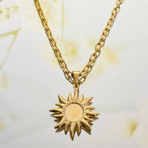 A radiant sun charm necklace that is perfect for layering. This unique charm has a reflective center and lightweight characteristic that makes it ideal for gifting. It symbolizes abundance, warmth, and new beginnings. ⭐️Item Details: Chain Width: 2.5mm Pendant Size: 25 x 24mm Benefits: Water Resistant & Hypoallergenic ⭐️About Our Necklaces: Our necklace collection is made to best suit your personality and style. While we do offer the option to purchase individual statement necklaces, we highly e Sun Necklace Men, Sun Pendant Gold, Sun Amulet, Gold Sun Necklace, Gold Pendants For Men, Gold Jewelry Prom, Sun Jewelry, Sunshine Necklace, Celestial Sun