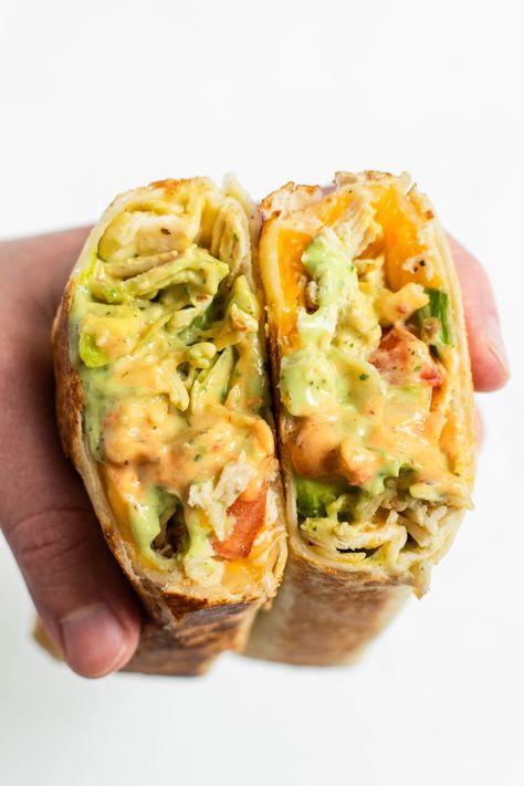 This copycat recipe for Taco Bell's chipotle ranch grilled chicken burritos features grilled chicken, Mexican blend cheese, lettuce, tomatoes, avocado, and tortilla strips wrapped in a toasted tortilla and drizzled generously with avocado ranch and chipotle ranch dressings. #chipotleranchgrilledchickenburrito #copycatrecipe #tacobellburrito #chickenburrito #burrito #burritorecipe #chickenrecipe Chicken Avocado Wrap, Burrito Ingredients, Chipotle Chicken Bowl, Chipotle Ranch, Chicken Wrap Recipes, Best Meal Prep, Chicken Burritos, Burritos Recipe, Food Test