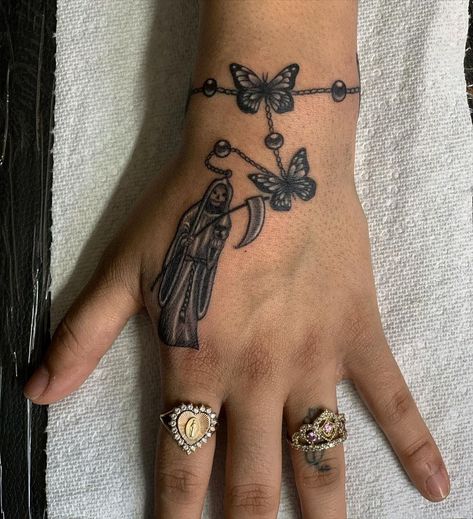 31 Santa Muerte Tattoos: The Meaning Behind This Powerful Design - Body Artifact Santa Muerte Hand Tattoo, Small Santa Muerte Tattoo, Santa Muerte Tattoo Pequeño, La Santa Muerte Drawing, Santisima Muerte Tattoo, Santa Muerte Tattoo For Women, Santa Muerte Nails, Santa Muerte Drawing Tattoo, Santa Muerte Tattoo Stencil